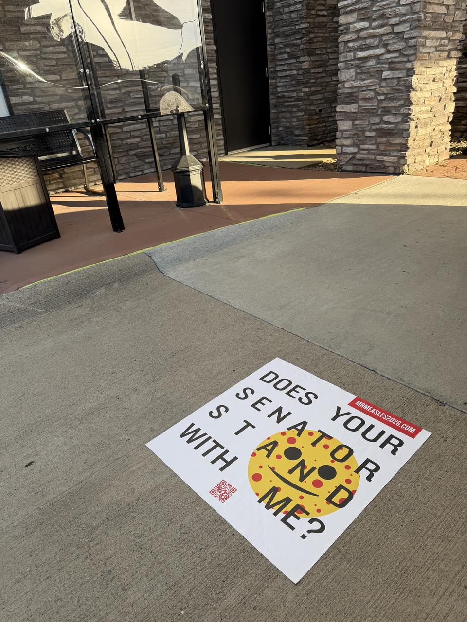 Sidewalk decal at a bus shelter, Sioux City, IA