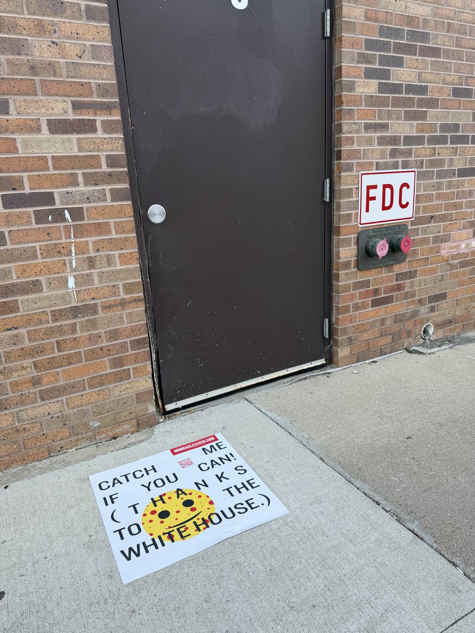 Sidewalk decal in a storefront doorway, Sioux City, IA